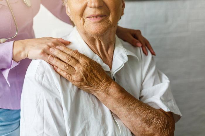 Woman holding carers hand
